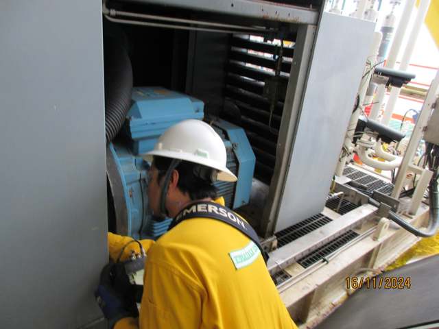Technician performing alignment and balancing on rotating machinery