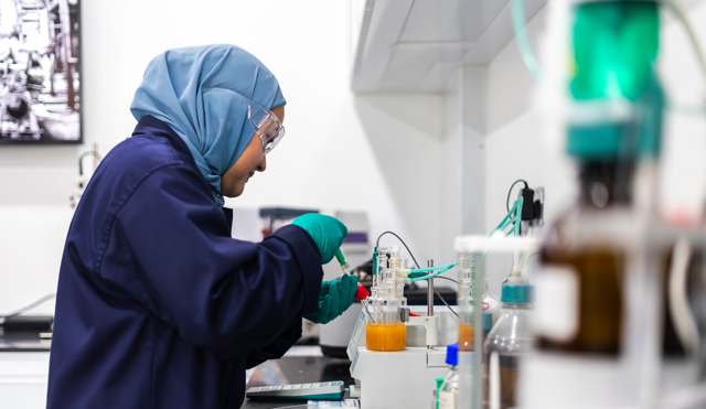 Technician performing oil condition monitoring in the lube oil laboratory